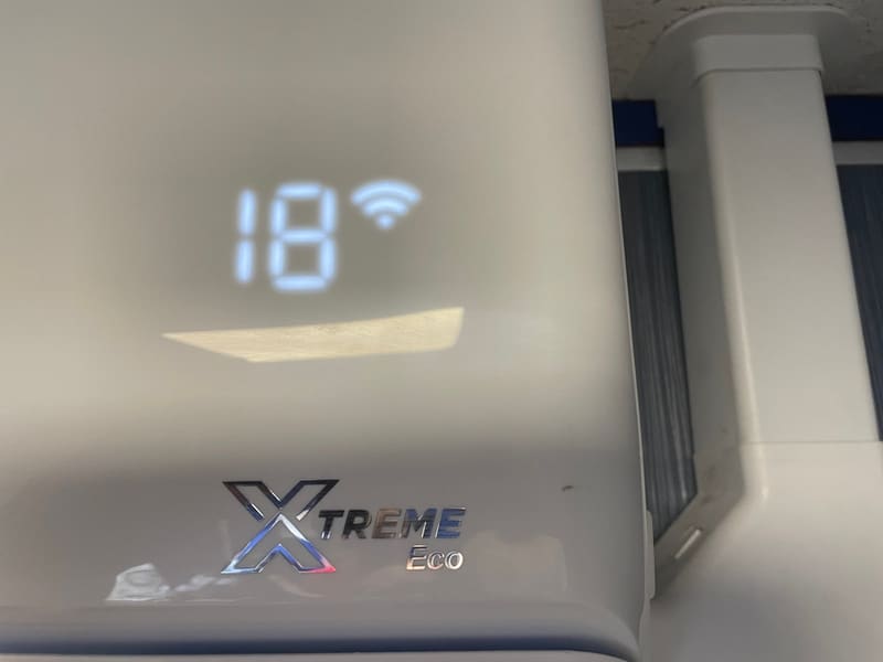 Air conditioning unit temperature display showing 18 degrees