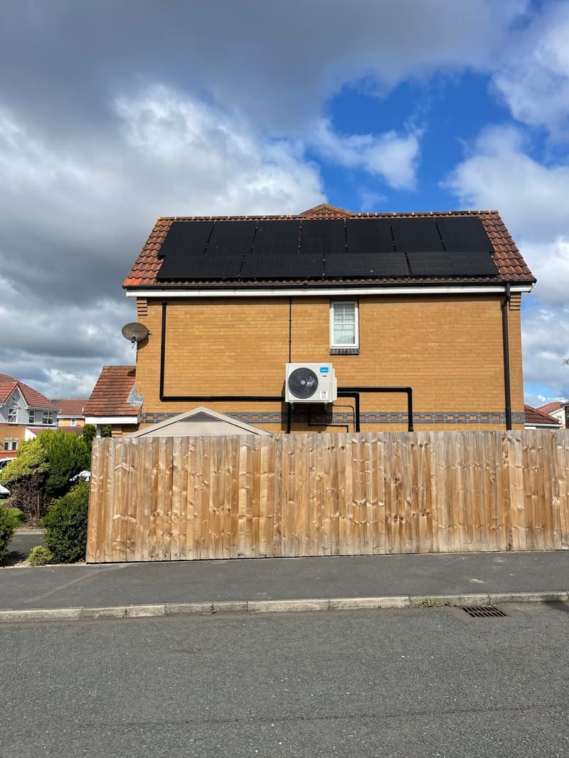 Air conditioning outdoor unit installed on the side of a detached house in Kent