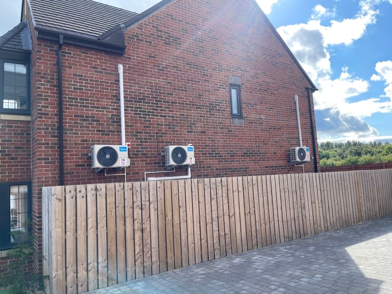 Outdoor units for a multi-room home air conditioning system on a brick house