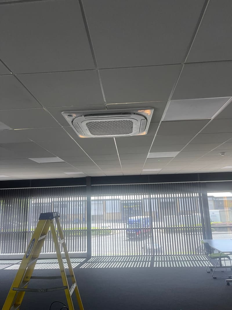 Recessed ceiling cassette air conditioning unit in a suspended office ceiling