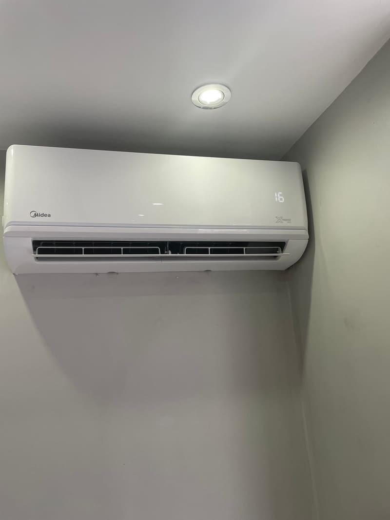 Close-up of a freshly installed wall-mounted air conditioning indoor unit